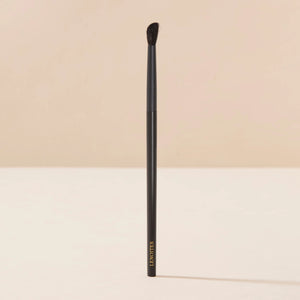 Brush Me Blending Angled Brush No. 103 by Lenoites, featuring a sleek black handle and a soft angled brush head, displayed against a soft beige background.