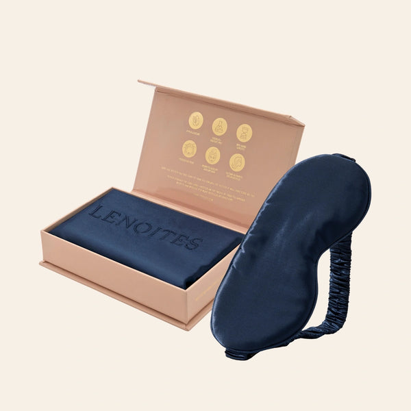 Pillowcase and Sleep Mask in Mulberry Silk by Lenoites featuring a blue silk sleep mask and a blue mulberry silk pillowcase presented in an open blush pink box against a soft light background.
